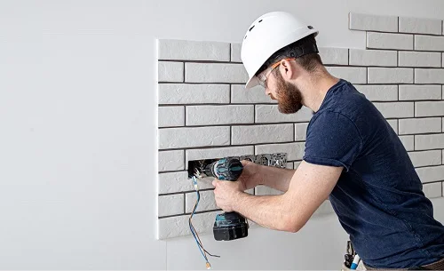 a residential electrician in City of Virginia Beach installing new electrical wiring for electrical sockets